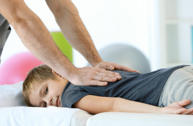 chiropractor working on kid patient