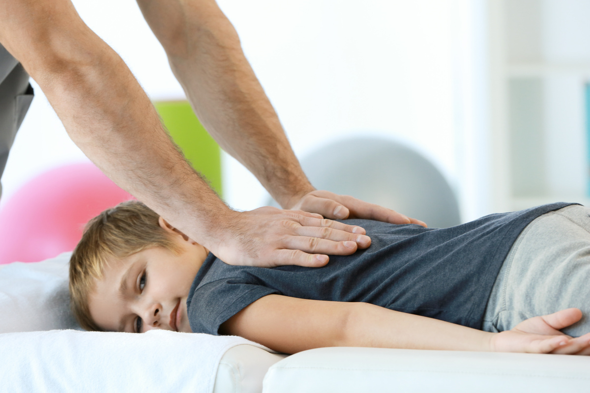 chiropractor working on kid patient
